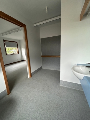 The ensuite has grabrails, a toilet and roll-in shower.