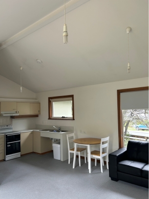 The open plan area in the unit has high ceilings, and is the perfect space to cook, eat and relax.
